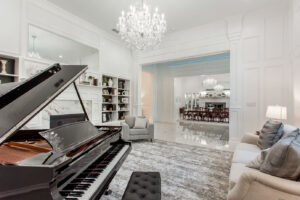 Picturesque evening reflection of Waxahachie luxury estate by private pond with elegant exterior lighting, waterfront views, and resort-style landscaping for tranquil Texas living.